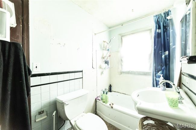 Full bath with wainscoting, bathing tub / shower combination, and tile walls | Image 15