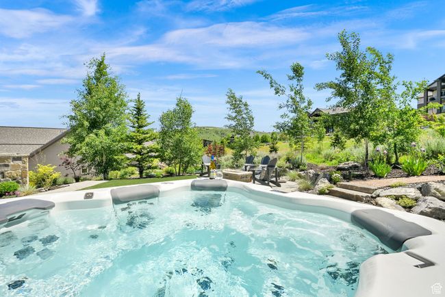 View of spa featuring an outdoor fire pit and a patio | Image 68