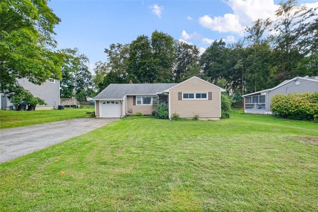 View of front facade featuring a front yard and a garage | Image 28