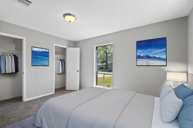 The generously sized secondary bedroom offers plenty of space to unwind, complemented by a large window that brings in natural light. With ample closet space, it provides both comfort and practicality for any occupant. | Image 24