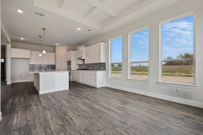 Kitchen featuring stainless steel microwave, dark wood-type flooring, baseboards, and visible vents | Image 9