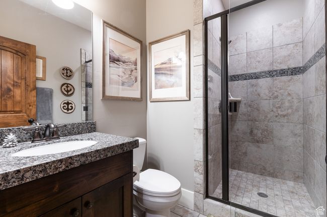 Bathroom featuring vanity, a stall shower, and toilet | Image 14