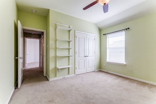 Unfurnished bedroom with carpet, a closet, lofted ceiling, and ceiling fan | Image 23