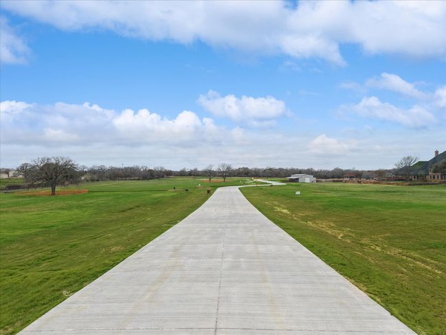 Concrete road into neighborhood | Image 9