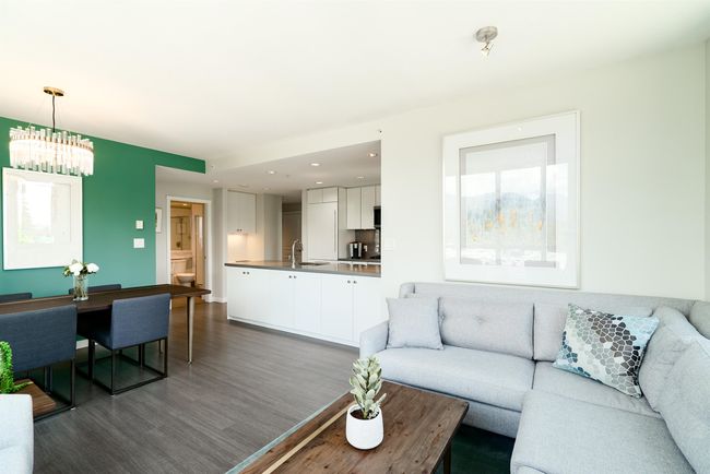 Living area with dark wood-style flooring, a chandelier, and recessed lighting | Image 12