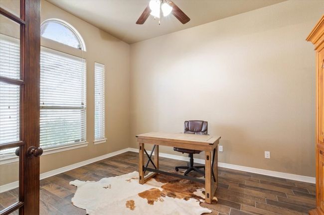 Home office featuring baseboards, ceiling fan, and dark wood-style flooring | Image 8
