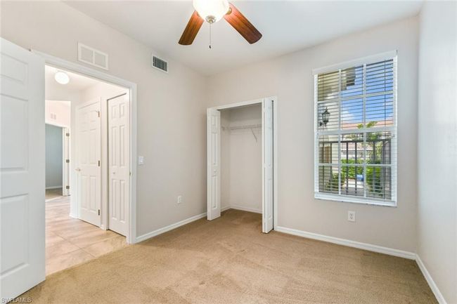 Unfurnished bedroom with baseboards, visible vents, a ceiling fan, and light colored carpet | Image 29