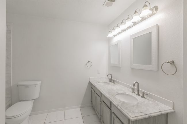 Bathroom with double vanity and toilet | Image 20