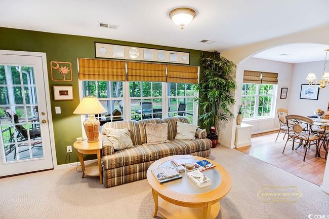 Living area featuring arched walkways and a chandelier | Image 13