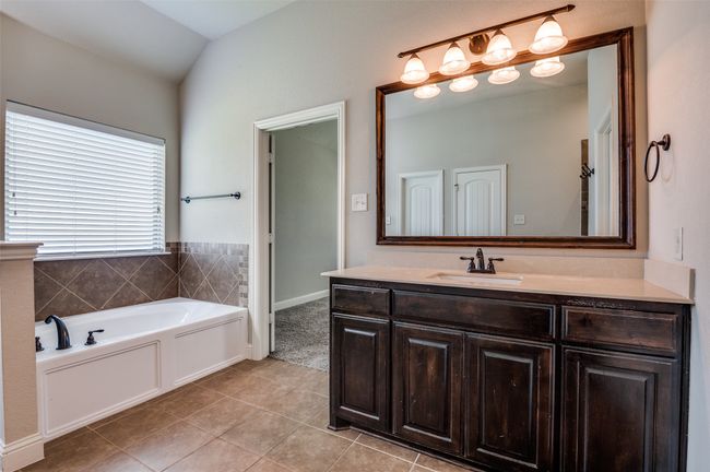 Bathroom with vanity, a bath, and tile patterned floors | Image 18