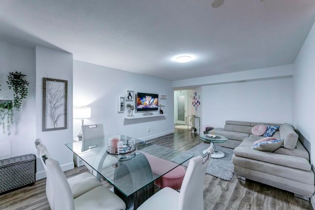 Dining area with baseboards and wood finished floors | Image 22