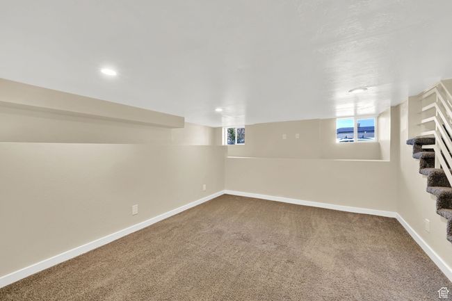 Basement with baseboards, carpet flooring, recessed lighting, and stairs | Image 19