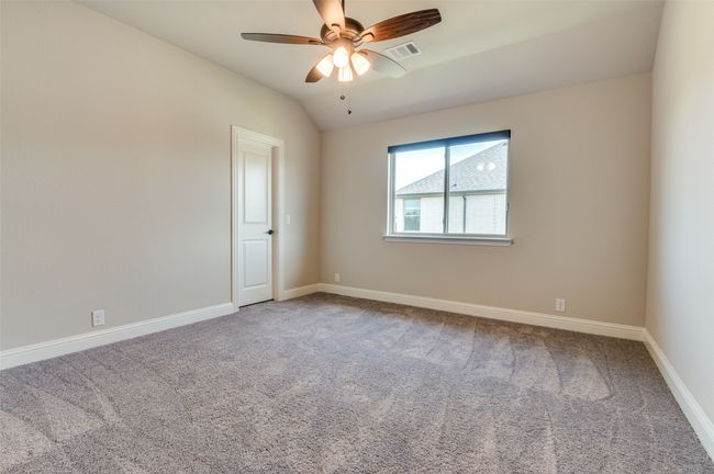 Carpeted spare room with vaulted ceiling and a ceiling fan | Image 29