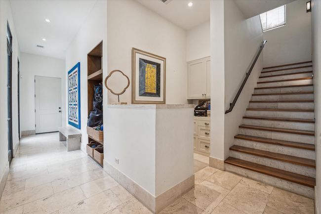 Just beyond the kitchen is the center stairs, a hidden office/work station, and the mud room. | Image 20