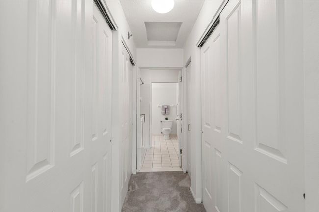 The primary bedroom's private access to the full bathroom, showcasing three closets to accommodate all your wardrobe needs. | Image 9