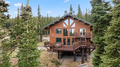 Rear view of property featuring a wooden deck | Image 1