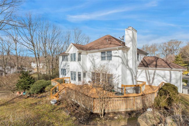 View of property exterior featuring a wooden deck | Image 24