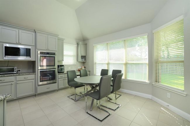Breakfast nook with bright natural light and Don't miss you this built in desk and planning area with cabinet dividers for organization. | Image 27