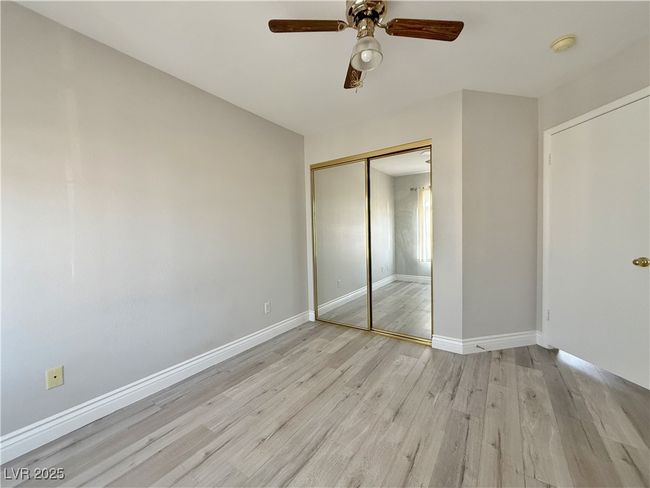 Unfurnished bedroom featuring a closet, light wood-style flooring, a ceiling fan, and baseboards | Image 38