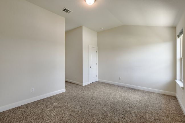 Carpeted spare room with baseboards and vaulted ceiling | Image 31