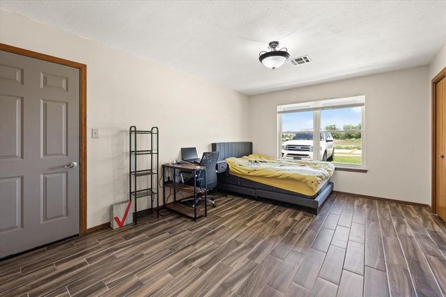 Bedroom with dark wood finished floors and baseboards | Image 30