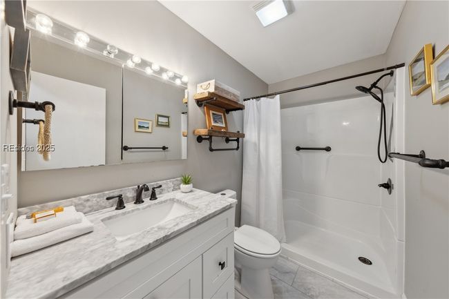 Primary ensuite bedroom with modern updated vanity and shower. | Image 48