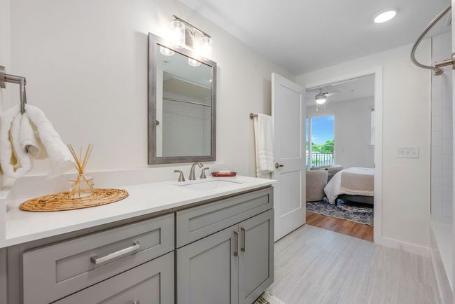 Bathroom featuring a shower, vanity, wood finished floors, and connected bathroom | Image 16