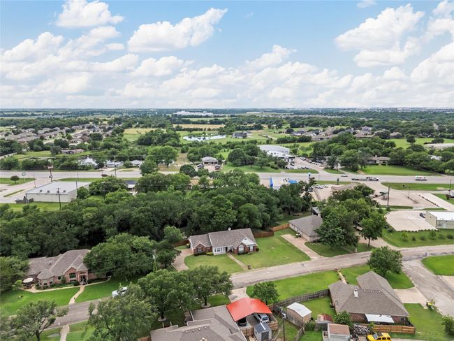 Aerial view of residential area featuring a tree filled landscape | Image 23