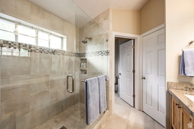 Bathroom featuring tile walls, toilet, and a sink | Image 17