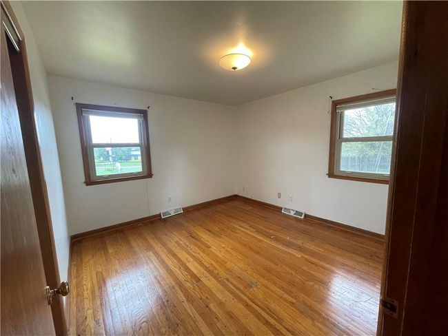Empty room featuring visible vents, a wealth of natural light, and light wood-type flooring | Image 12