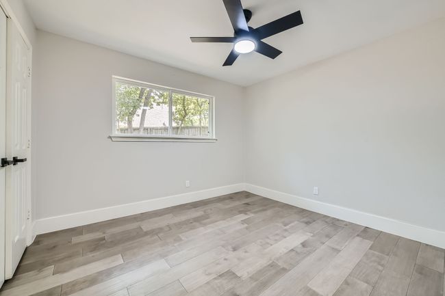 Unfurnished bedroom featuring baseboards, wood finished floors, and ceiling fan | Image 20