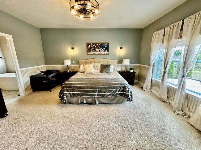Spacious primary with loads of natural light. | Image 18