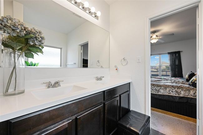 Bathroom featuring ensuite bathroom, healthy amount of natural light, double vanity, and a ceiling fan | Image 17