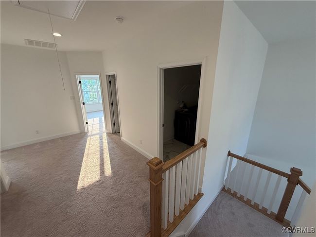 Corridor featuring attic access, an upstairs landing, carpet flooring, baseboards, and recessed lighting | Image 18