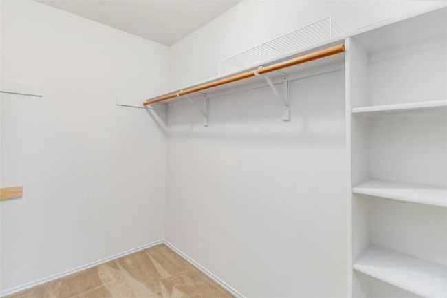 Spacious closet with light carpet | Image 25