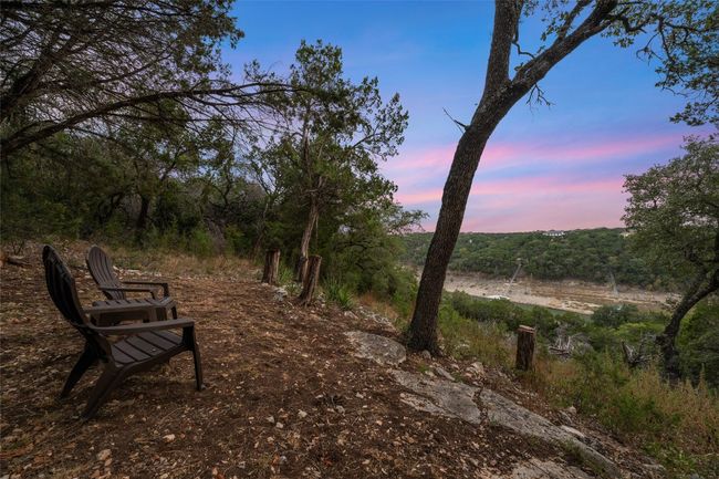 This secluded seating area offers a picturesque view of the hillside & Devils Cove (depending on lake levels) at sunset, perfect for unwinding and taking in the beauty of the surrounding landscape. | Image 25