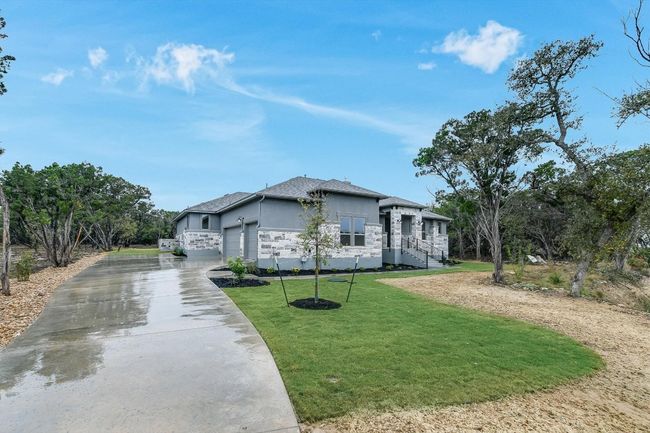 View of front facade featuring a front lawn, stucco, a garage, and concrete driveway | Image 4