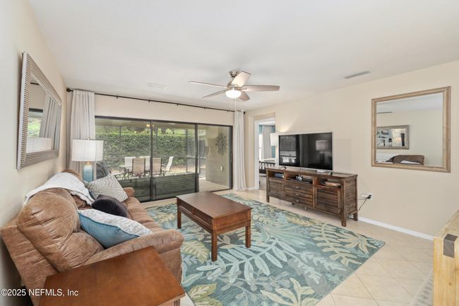 Bright and welcoming family room with open flow to the kitchen and lanai. | Image 9