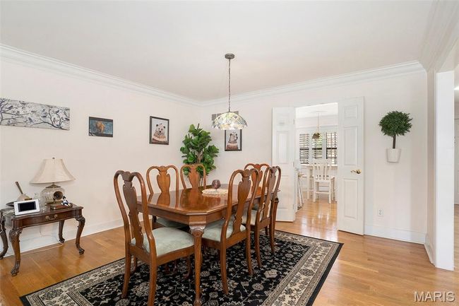 Dining area featuring ornamental molding and light wood-type flooring | Image 5