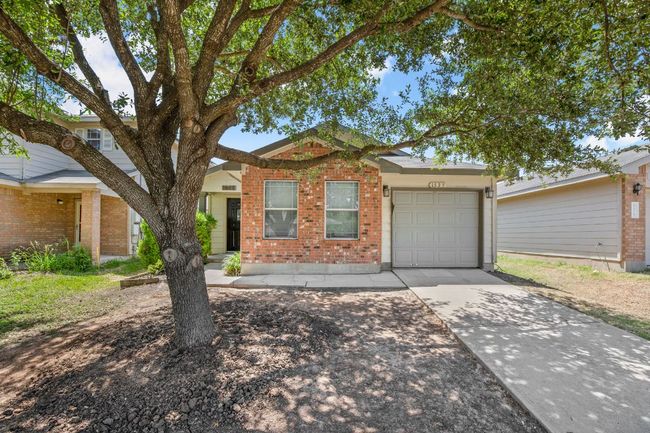 View of front of property with an attached garage, driveway, and brick siding | Image 20