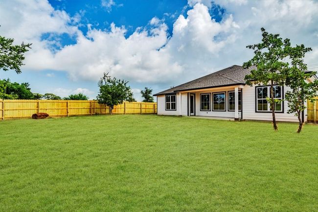 Rear view of house featuring a fenced backyard and roof with shingles | Image 31