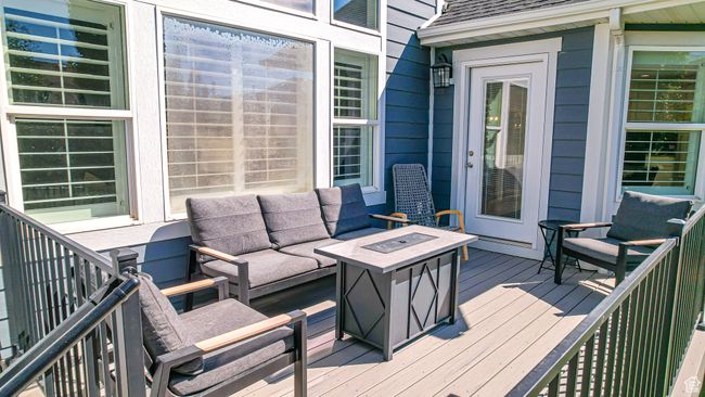 Wooden terrace with an outdoor living space with a fire pit | Image 56