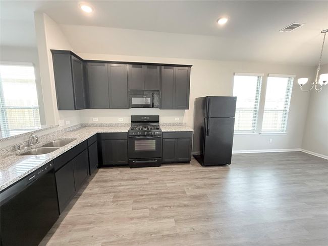 14501 SUGAR PINES DR - Kitchen with all black appliances, refrigerator included | Image 14