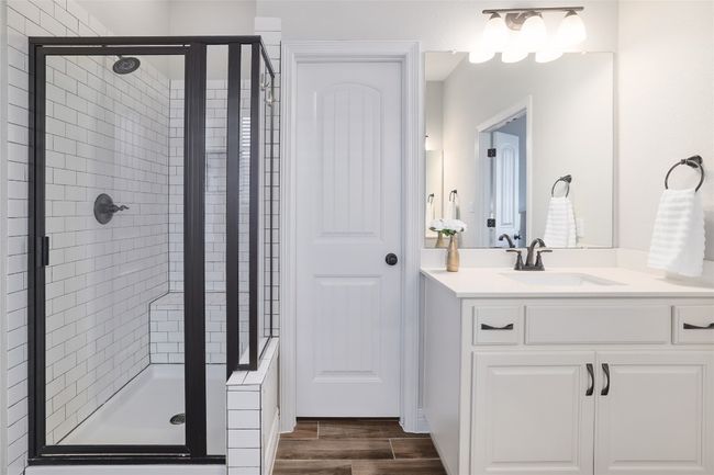 Full bath with a walk-in shower, a garden tub, dual vanity, and wood finished floors | Image 22