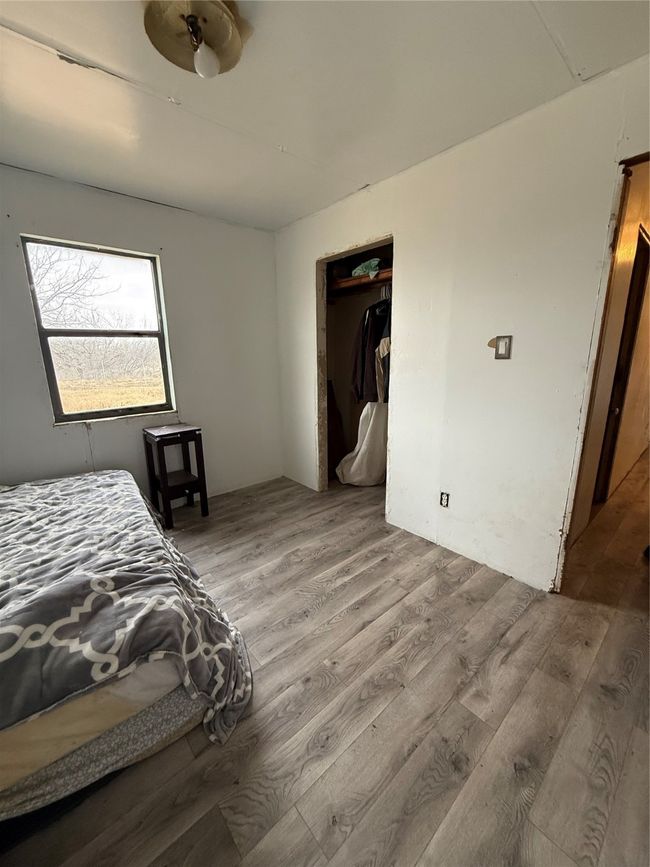 Bedroom with a closet and light wood-type flooring | Image 9