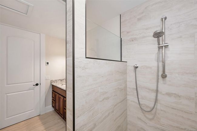 Bathroom featuring a tile shower and vanity | Image 54
