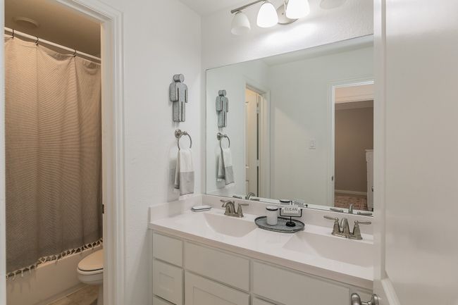 Full bathroom featuring double vanity and toilet | Image 25