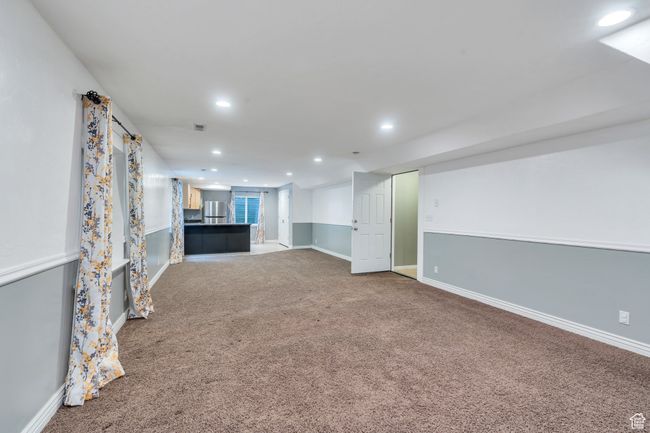Unfurnished living room with carpet, baseboards, and recessed lighting | Image 22