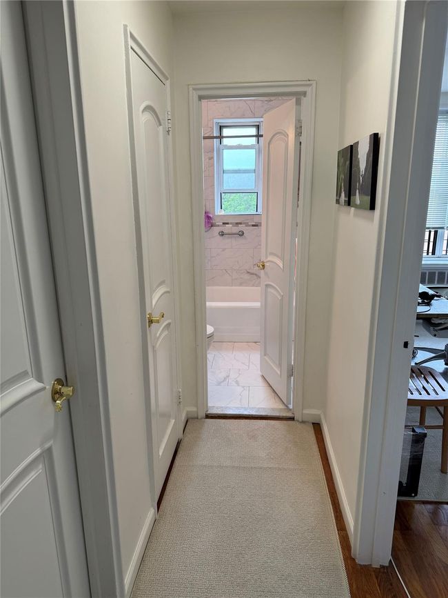 Hall with baseboards and marble finish flooring | Image 13