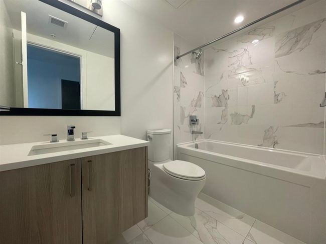 Bathroom with marble finish floors, vanity, and shower / tub combination | Image 13